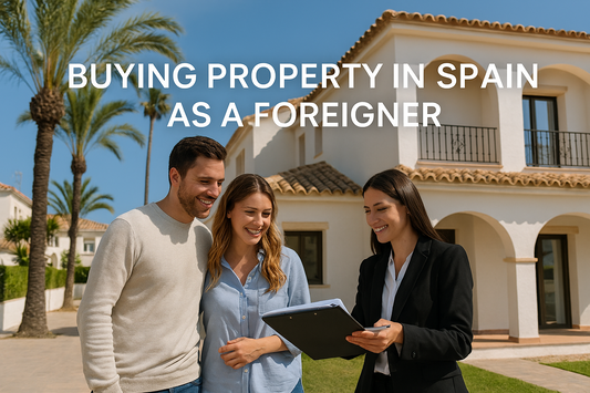 Foreign couple with real estate agent outside a Spanish villa discussing property purchase — Buying Property in Spain as a Foreigner.
