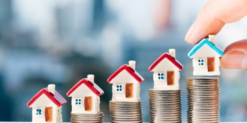 Cadastral reference Spain — stacked coins with model houses representing rising property value and registration in Spain